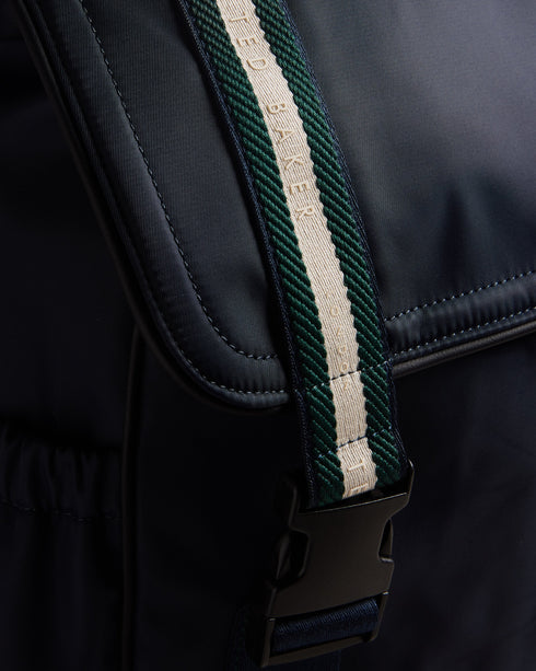 MATEW-Bags-The ultimate backpack for your on-the-go lifestyle, MATEW combines functionality with a bold, fashionable design. Featuring webbing details and side release buckles, this backpack is made to last. The top handle and adjustable shoulder straps make it easy to carry and the elasticated side pocket adds an extra level of convenience. A silicone logo patch finishes the look. The shell fabric of this product is made of 100% recycled polyester. Using recycled polyester helps divert plastic waste from e